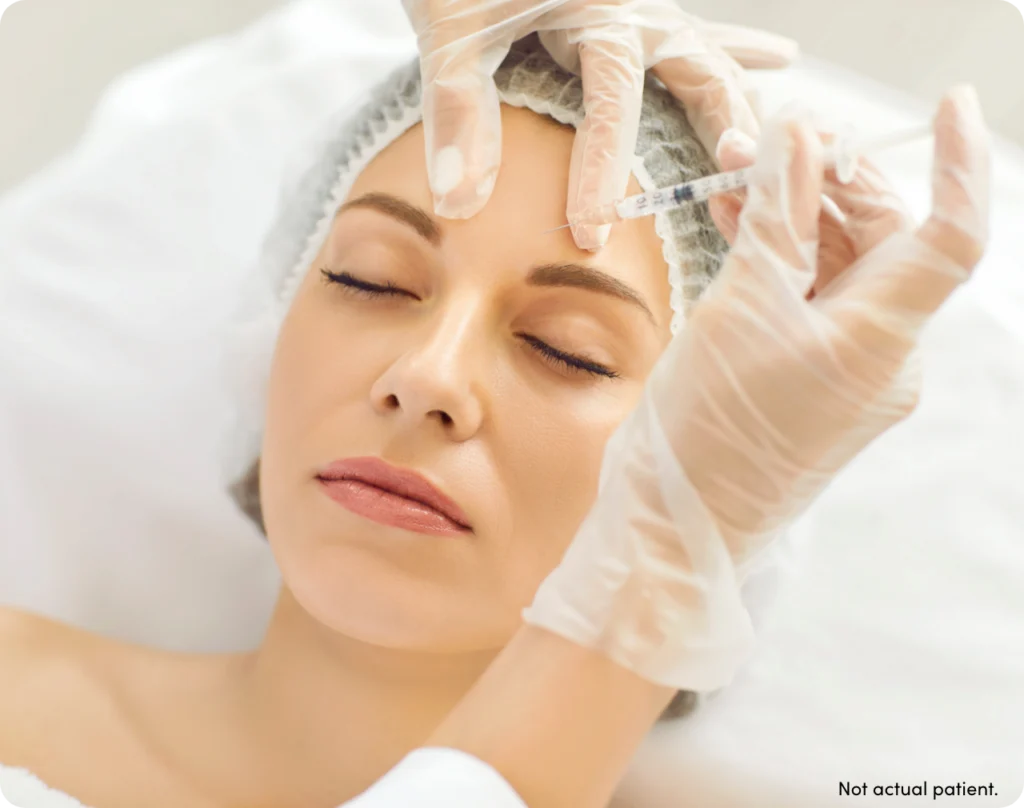 Woman with hair net being injected with XEOMIN with text 'not actual patient'