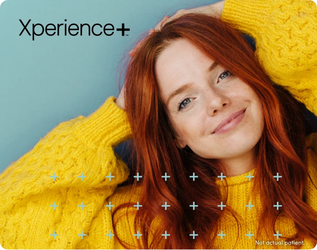 Redhaired woman smiling with text Xperience+