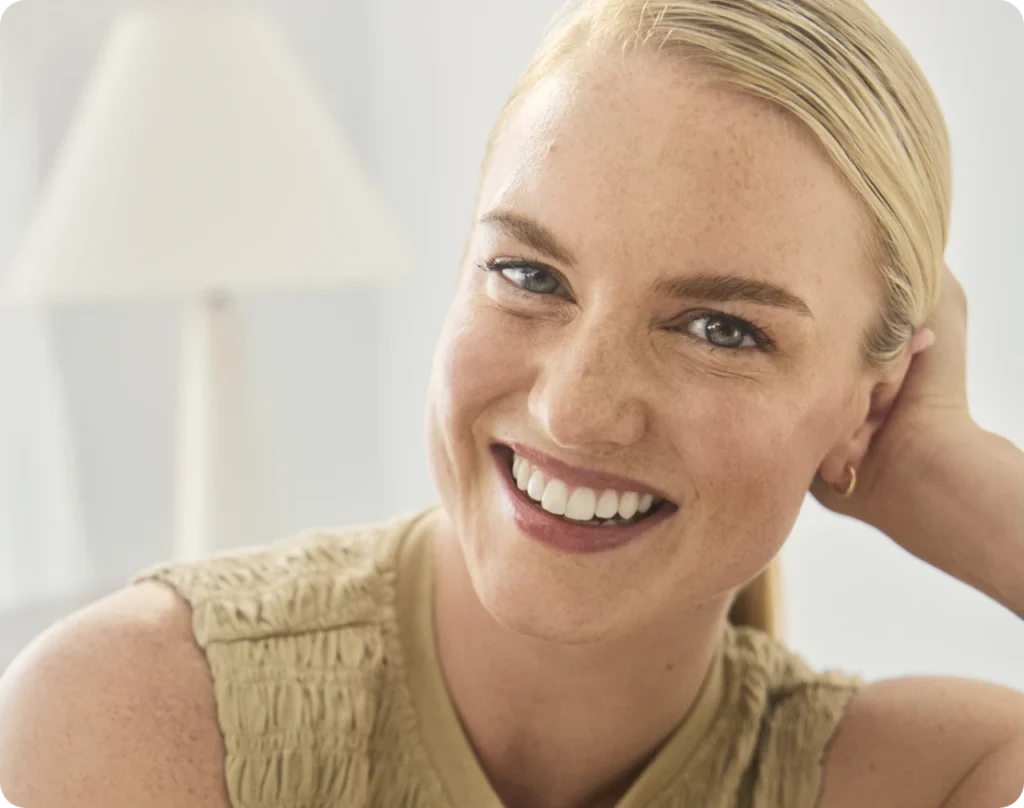 Blonde woman smiling.