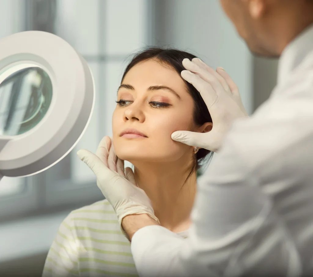 Woman with light on her face consulting with injector.