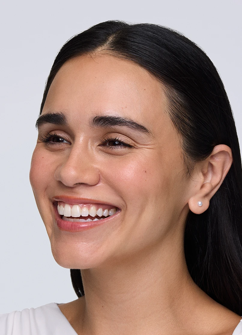 Patient Priscilla smiling with lines outside her eyes.
